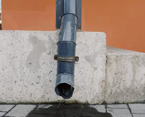 Water dripping out of a drainage spout.