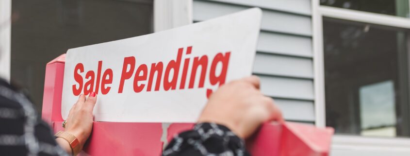 Picture of hands holding a “sale pending” sign